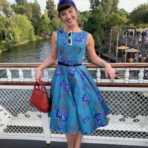 Retro dress in a teal butterfly pattern.